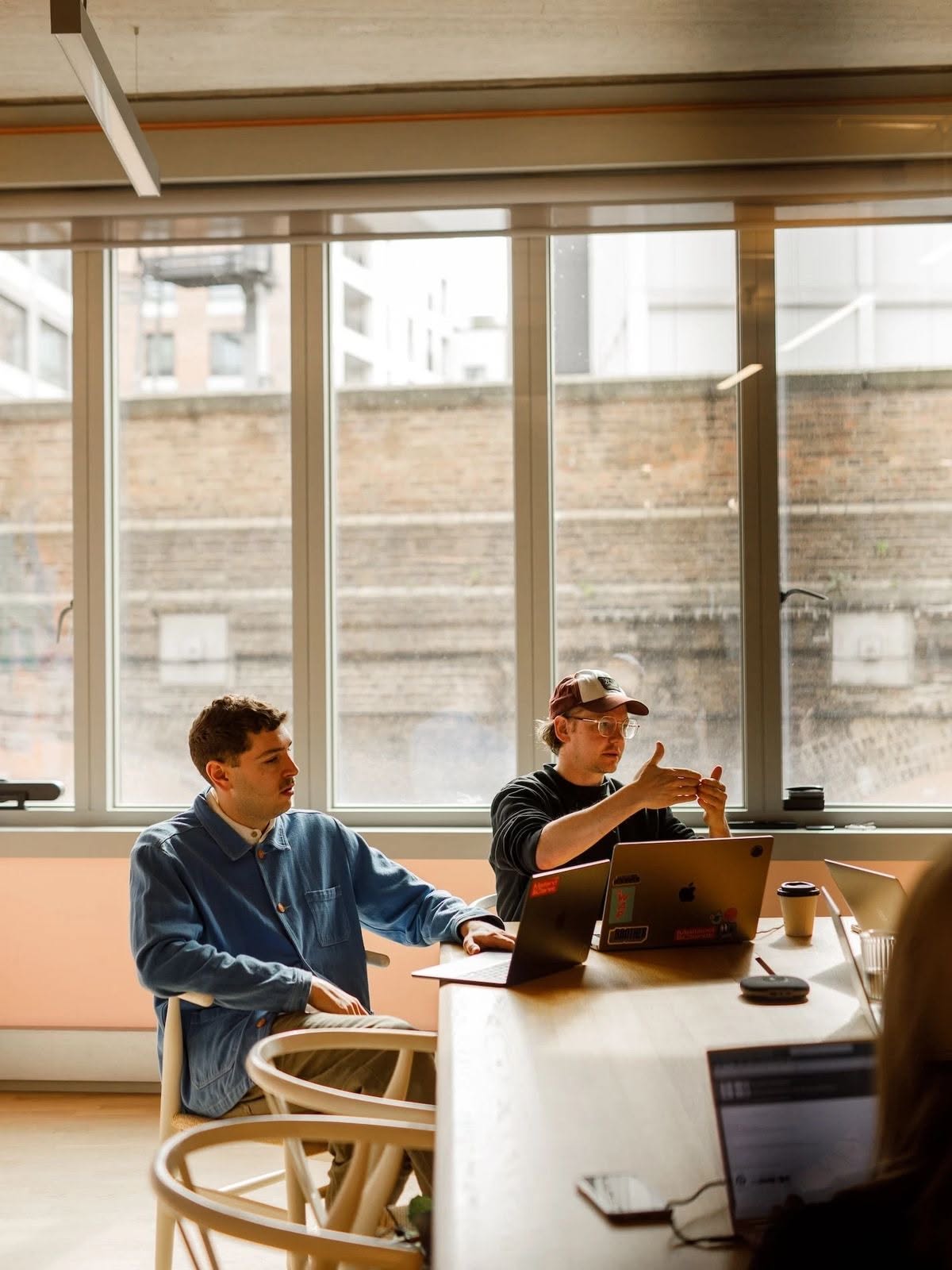 Two Pulse Motion strategists reviewing content on laptops in the Austin studio